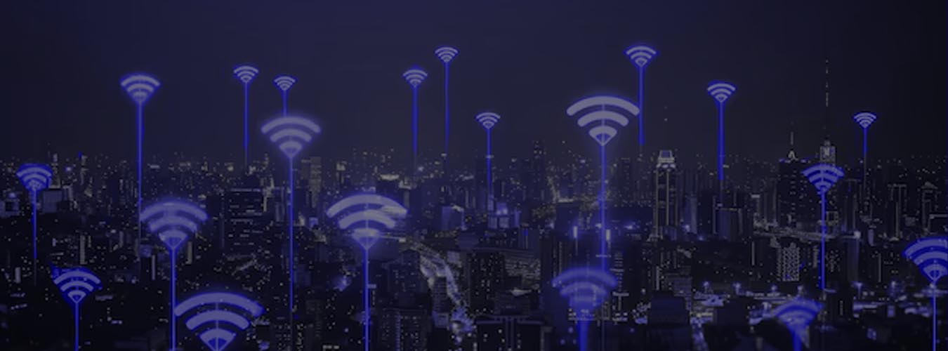 Night city skyline illuminated with multiple WiFi signals, showing widespread connectivity from an internet provider in Lahore.